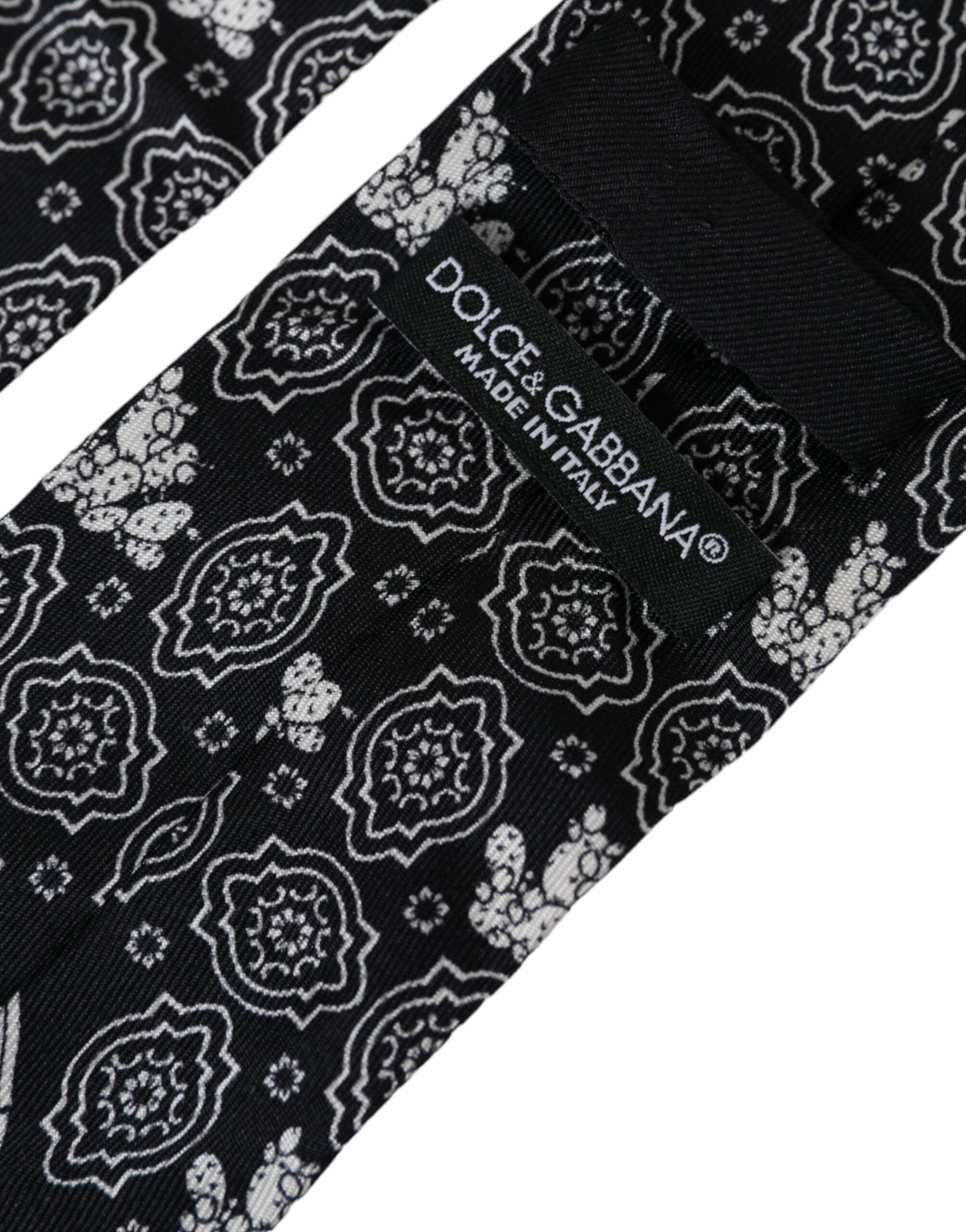 Black patterned 100% silk adjustable tie by Dolce & Gabbana displayed on a neutral background.
