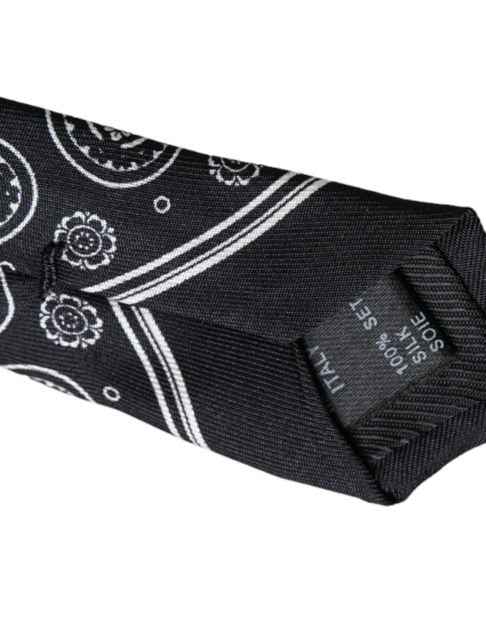 Black patterned 100% silk adjustable tie by Dolce & Gabbana, featuring intricate design and sleek finish.