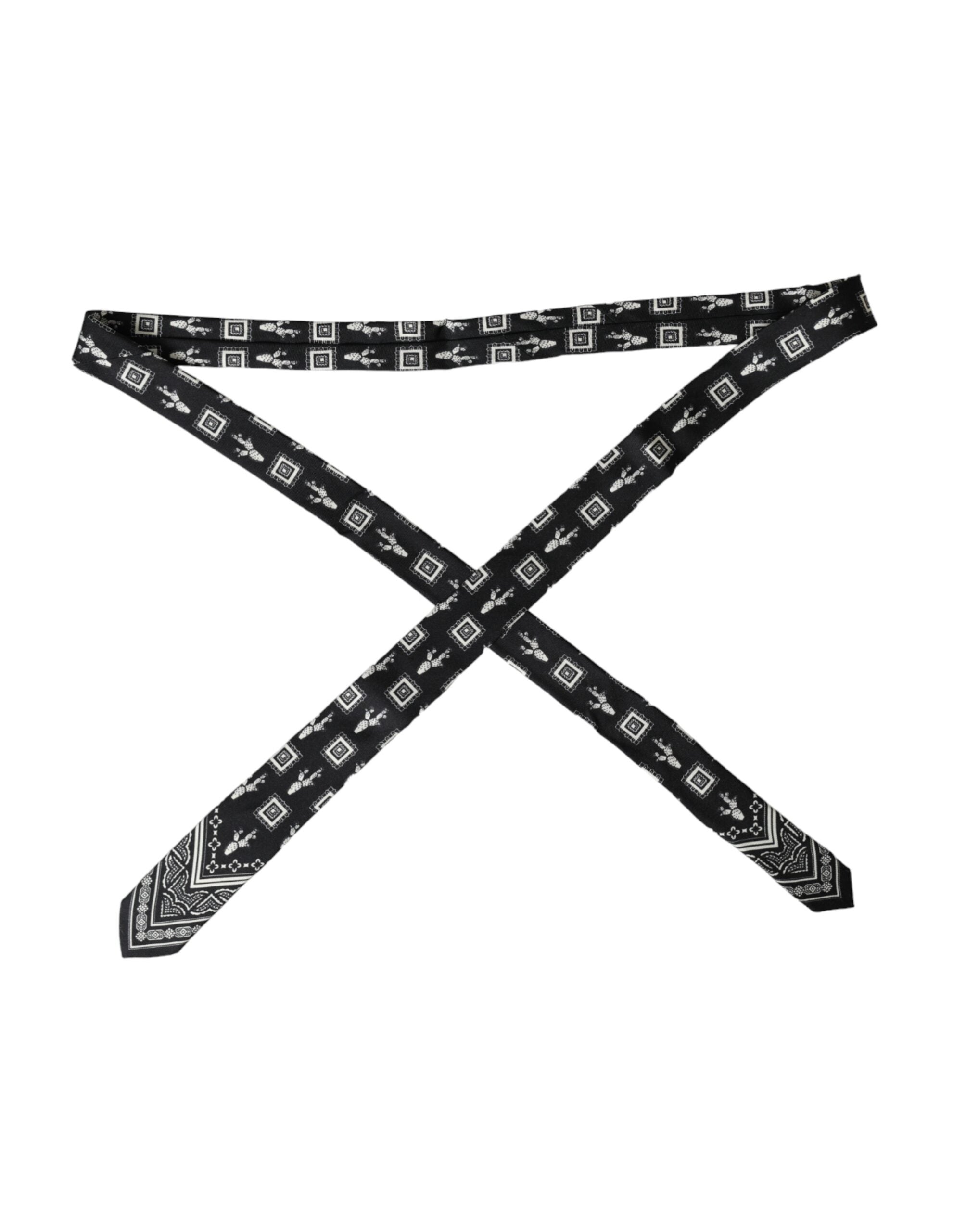 Black patterned 100% silk adjustable tie by Dolce & Gabbana with intricate print and classic knot style.