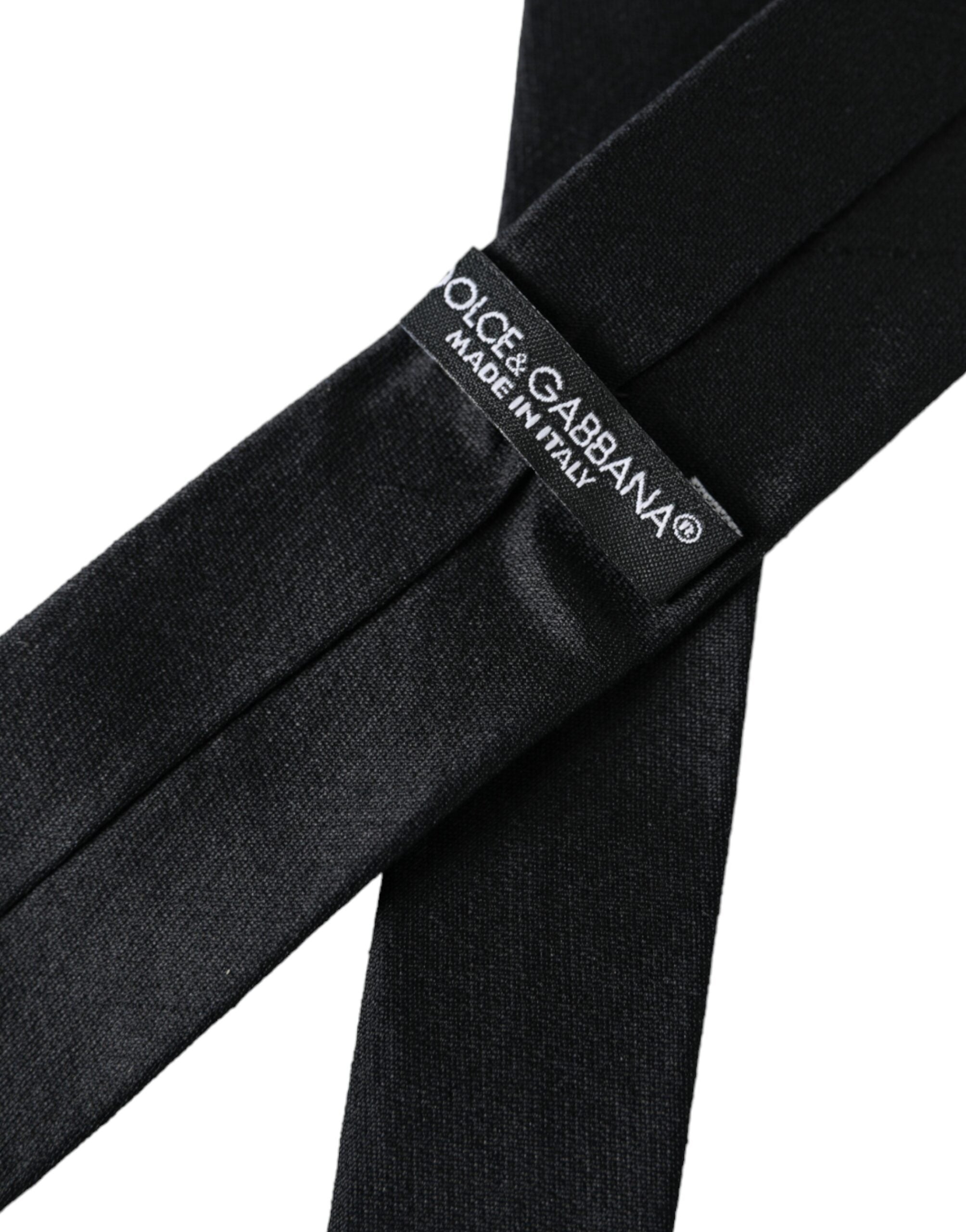 Black solid 100% silk adjustable tie by Dolce & Gabbana, featuring a sleek and elegant design for formal wear.