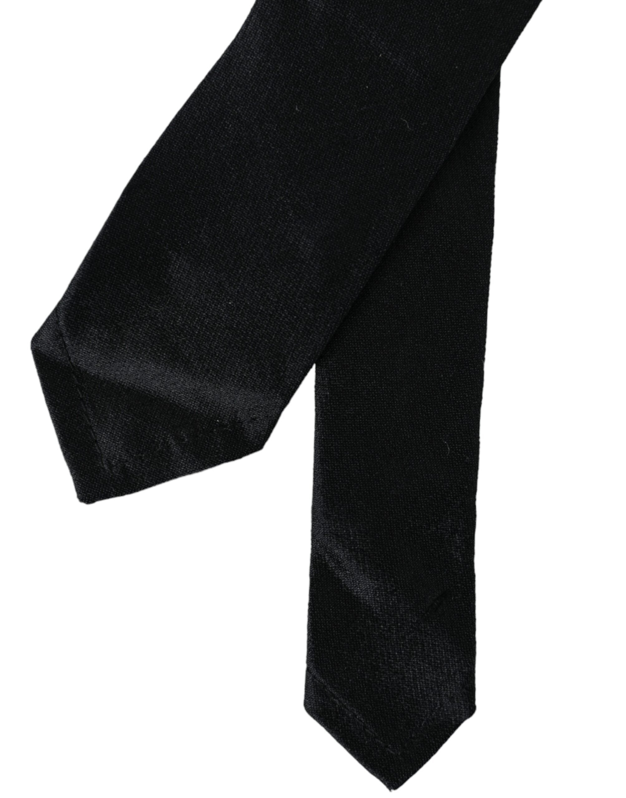 Black solid 100% silk adjustable tie by Dolce & Gabbana, featuring a sleek, smooth fabric and classic design.