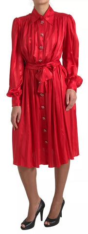 Red satin silk midi dress with button-down front and belt, designed by Dolce & Gabbana, shown on a model.