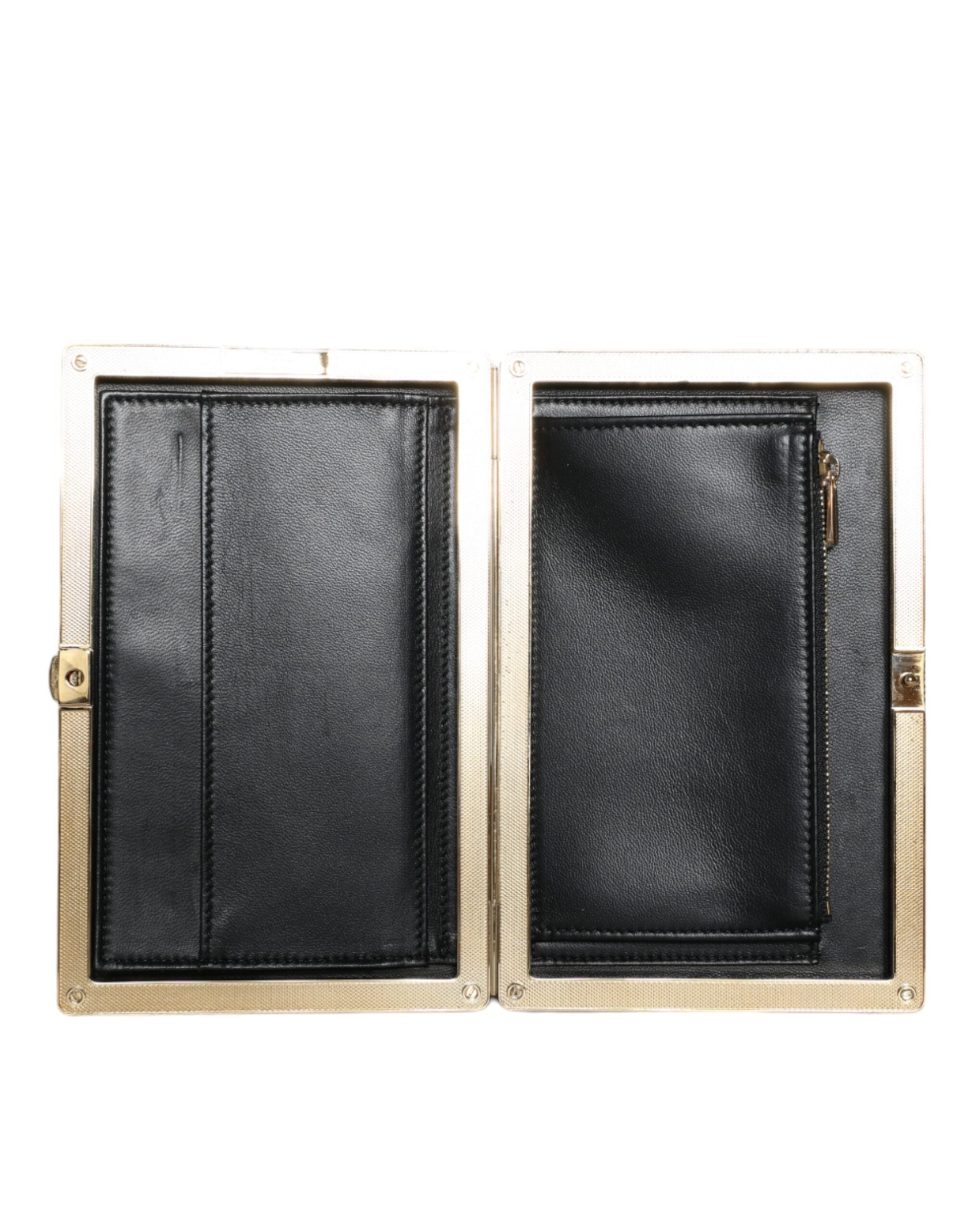 Black velvet clutch purse with gold frame by Dolce & Gabbana, designed for evening parties and elegant occasions.