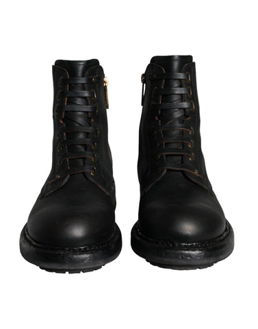 Black lace-up mid-calf men's boots by Dolce & Gabbana, featuring stylish leather design and sturdy sole.
