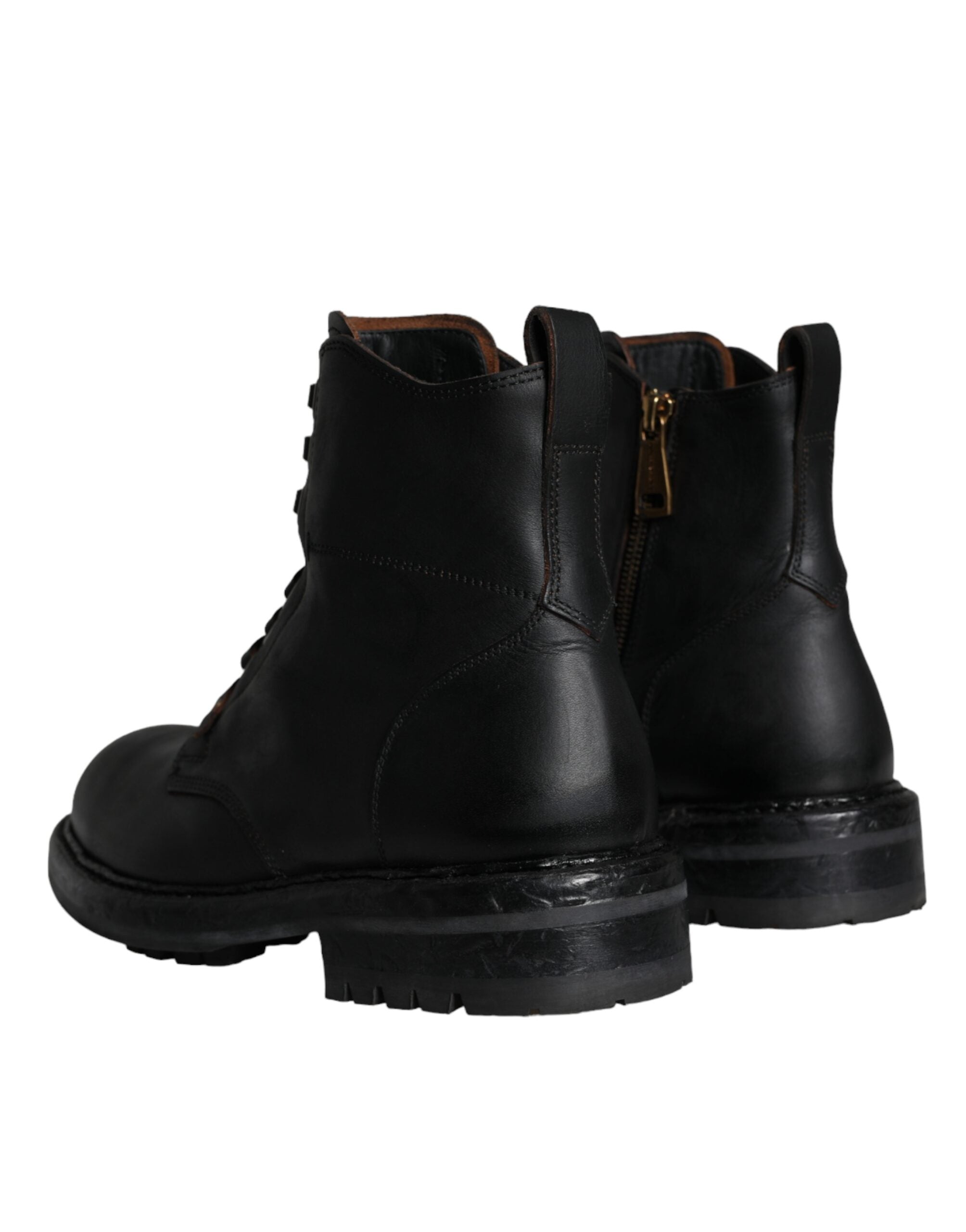 Black lace-up mid-calf men's boots by Dolce & Gabbana, featuring stylish leather design and rugged sole.