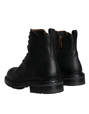 Black lace-up mid-calf men's boots by Dolce & Gabbana, featuring stylish leather design and rugged sole.