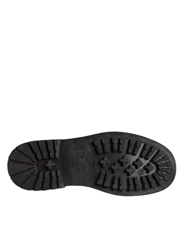 Black lace-up mid-calf boots for men by Dolce & Gabbana, featuring stylish design and sturdy sole.