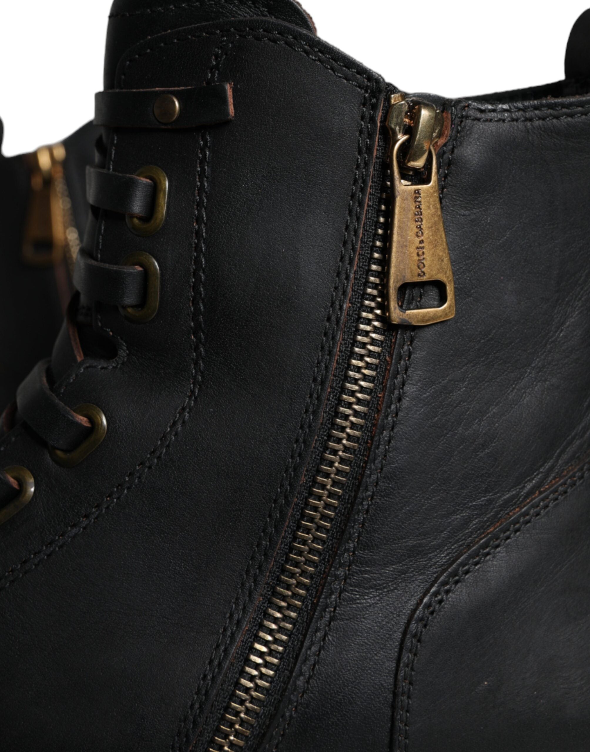 Black lace-up mid-calf men's boots by Dolce & Gabbana, stylish leather shoes with lace-up front and mid-calf height.
