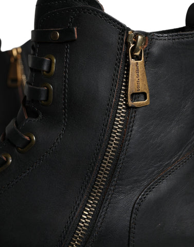 Black lace-up mid-calf men's boots by Dolce & Gabbana, stylish leather shoes with lace-up front and mid-calf height.