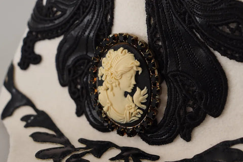 White and black wool embroidered cameo brooch on a hat, featuring intricate D&G Dolce & Gabbana craftsmanship.