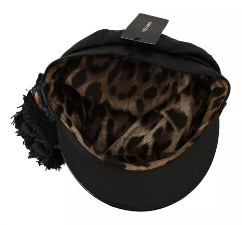 Black leather fiddler cap with crystal beads and gold ribbon detail by Dolce & Gabbana, stylish headwear for elegant fashion.