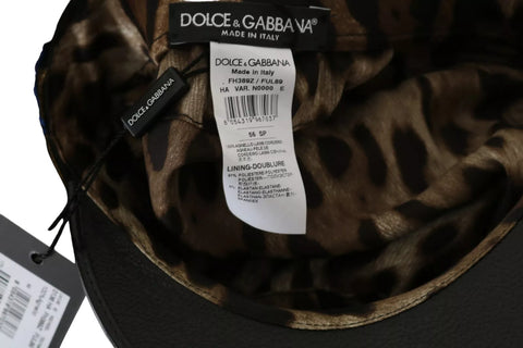 Black leather fiddler cap with gold ribbon and crystal bead accents, stylish accessory from Dolce & Gabbana.