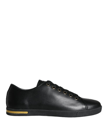 Black gold leather Dolce & Gabbana sneakers with classic design, featuring stylish laces and sleek silhouette.