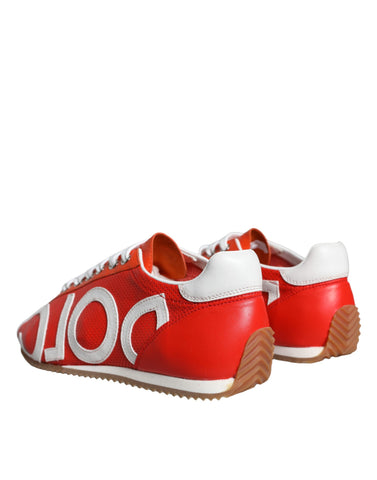 Red and white Dolce & Gabbana leather casual sneakers with logo detail on a plain background.