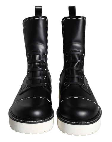 Black leather combat mid-calf boots by Dolce & Gabbana, featuring rugged design and sturdy sole for fashionable statement footwear.