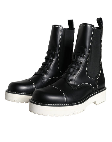 Black leather combat mid-calf boots by Dolce & Gabbana, featuring sturdy soles and stylish design.
