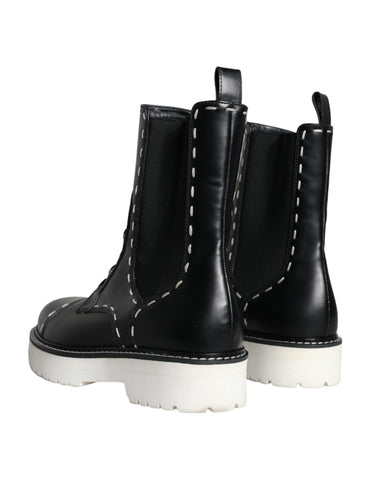 Black leather combat mid-calf boots by Dolce & Gabbana with lace-up front and sturdy sole.