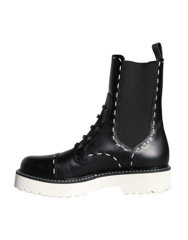 Black leather combat mid-calf boots by Dolce & Gabbana, featuring rugged design and sturdy soles.