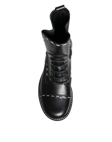 Black leather combat mid-calf boots by Dolce & Gabbana, featuring sturdy design and stylish mid-heel for everyday wear.