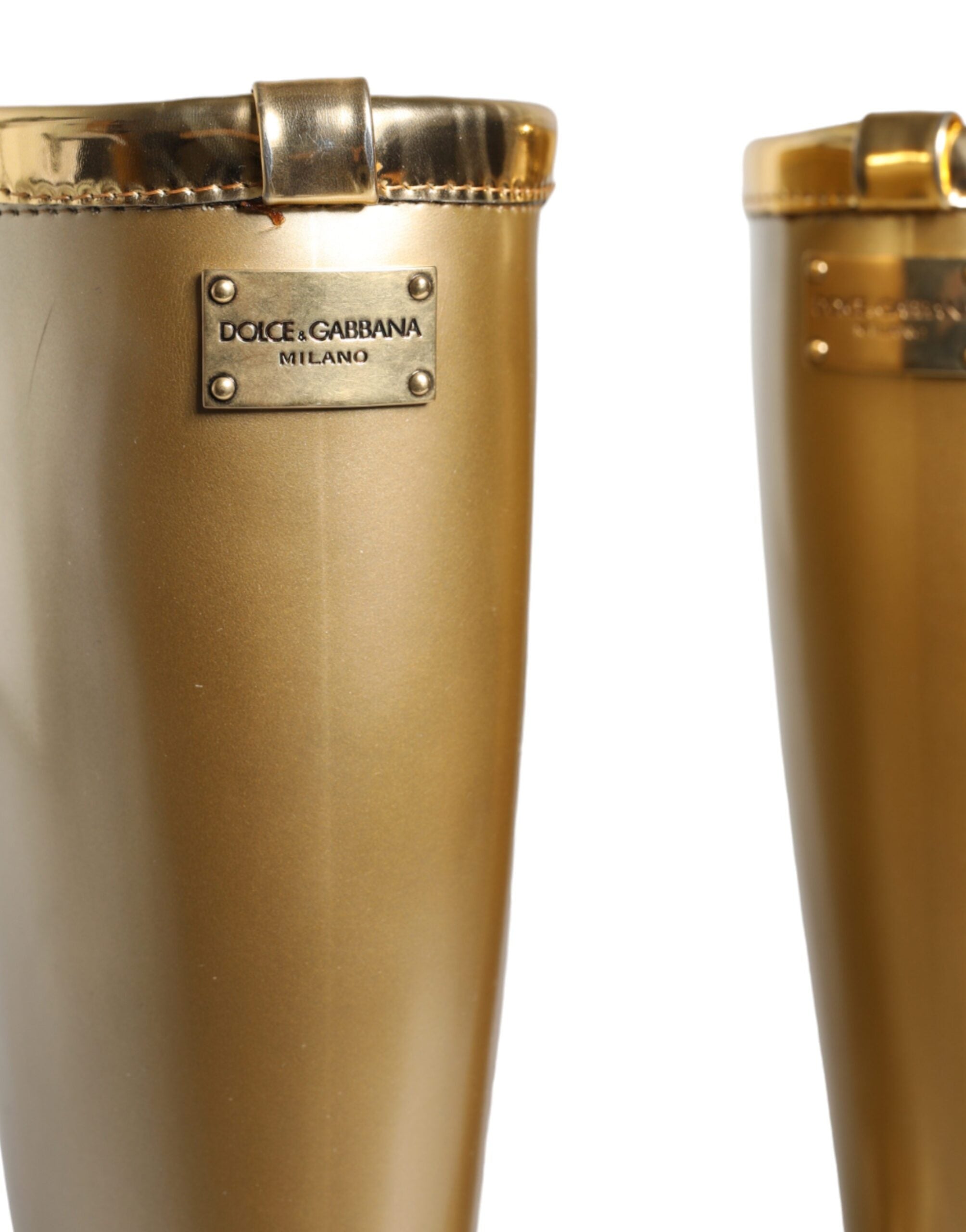 Metallic gold rubber PVC rain boots by Dolce & Gabbana with a glossy finish and classic tall design.
