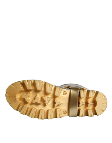 Metallic gold rubber PVC rain boots by Dolce & Gabbana, shiny waterproof footwear with a sleek design and sturdy sole.