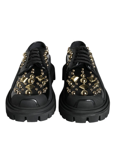 Black leather trekking derby shoes with embellishments by Dolce & Gabbana, featuring a sturdy sole and elegant design.