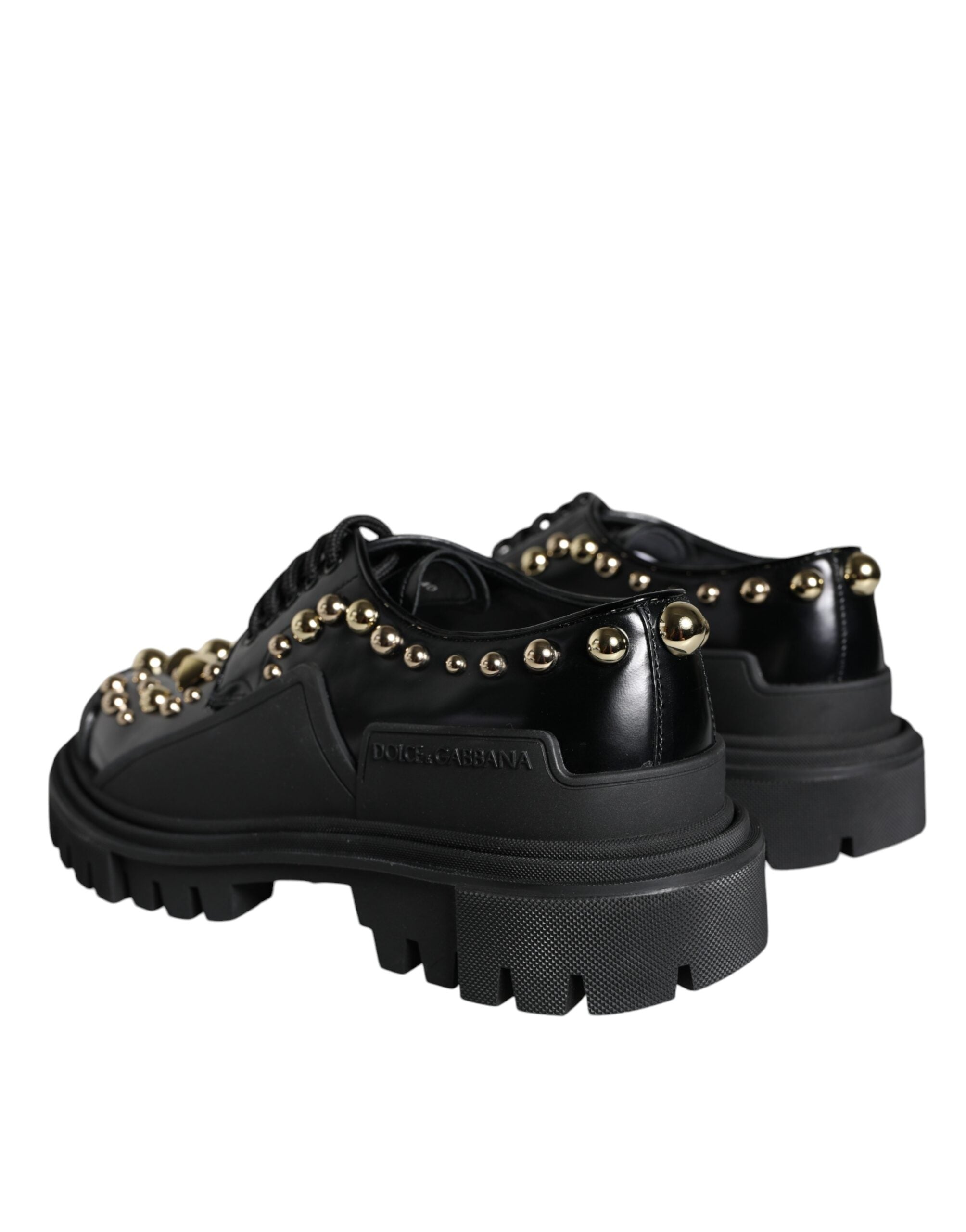 Black leather trekking derby shoes with embellishments by Dolce & Gabbana, featuring sturdy design and stylish detailing.
