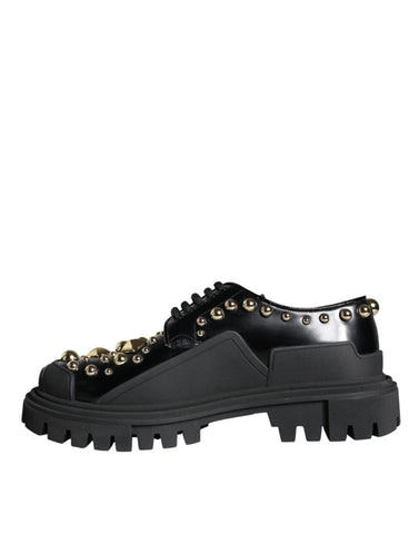 Black leather trekking derby shoes with embellishments by Dolce & Gabbana, featuring sturdy soles and stylish design details.