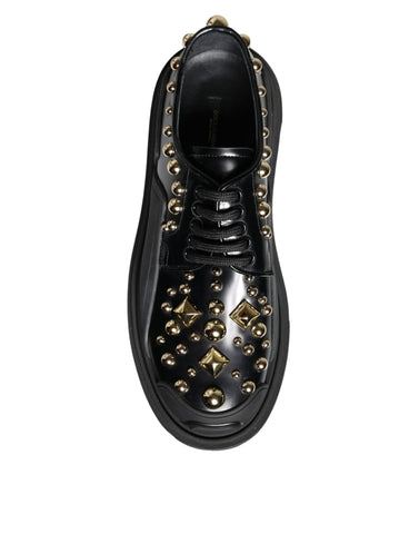 Black leather trekking derby shoes with embellishments by Dolce & Gabbana, featuring sturdy soles and stylish detailing.