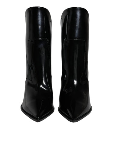 Black patent leather pointed ankle boots by Dolce & Gabbana, showcasing sleek design and stylish high-heeled footwear.
