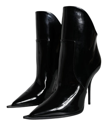 Black patent leather pointed ankle boots by Dolce & Gabbana, featuring sleek design and stylish ankle-length cut.