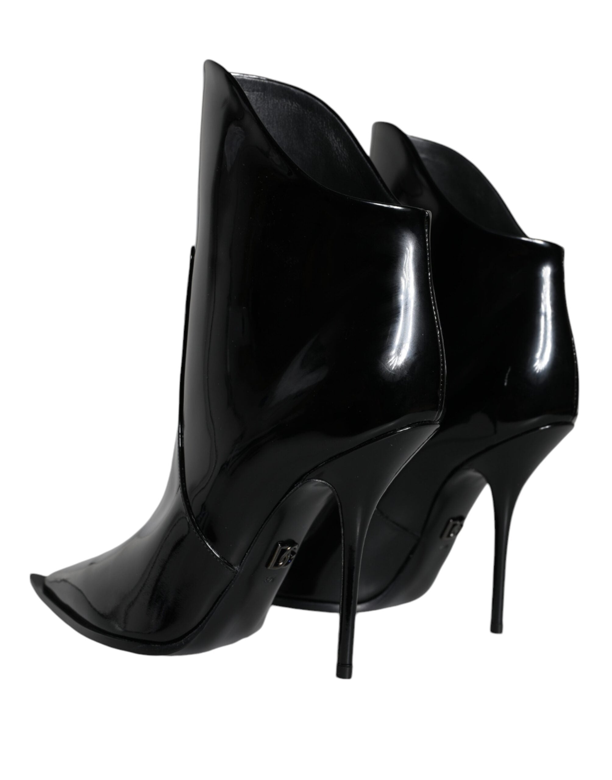 Black patent leather pointed ankle boots by Dolce & Gabbana, featuring sleek design and stylish ankle-length silhouette.