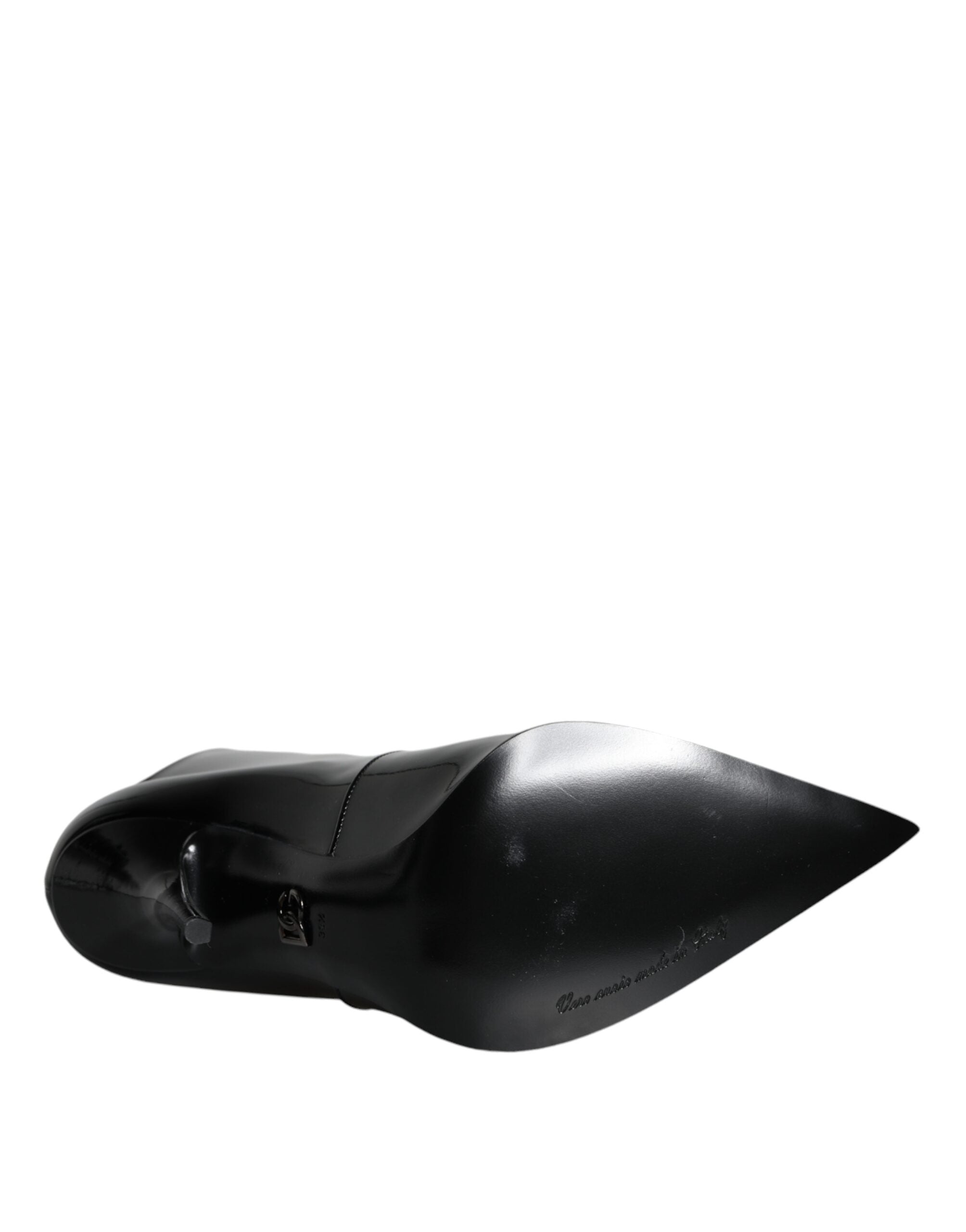 Black patent leather pointed ankle boots by Dolce & Gabbana, showcasing sleek design and stylish high-heeled footwear.
