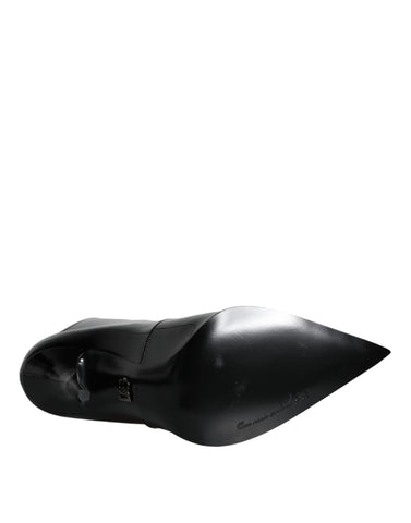 Black patent leather pointed ankle boots by Dolce & Gabbana, showcasing sleek design and stylish high-heeled footwear.