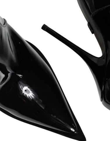 Black patent leather pointed ankle boots by Dolce & Gabbana, stylish footwear with sleek design and stiletto heel.