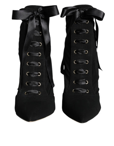 Black jersey stretch ankle booties by Dolce & Gabbana, featuring sleek design and pointed toes.
