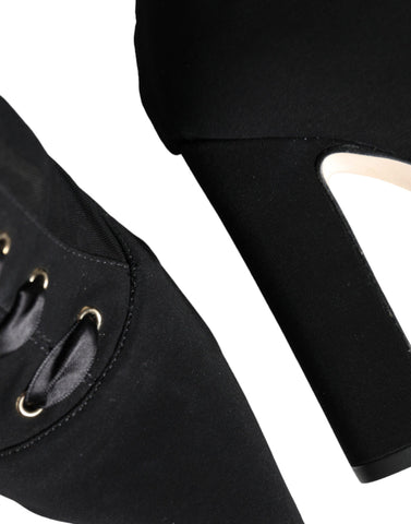 Black jersey stretch ankle booties shoes by Dolce & Gabbana with sleek design and pointed toes.