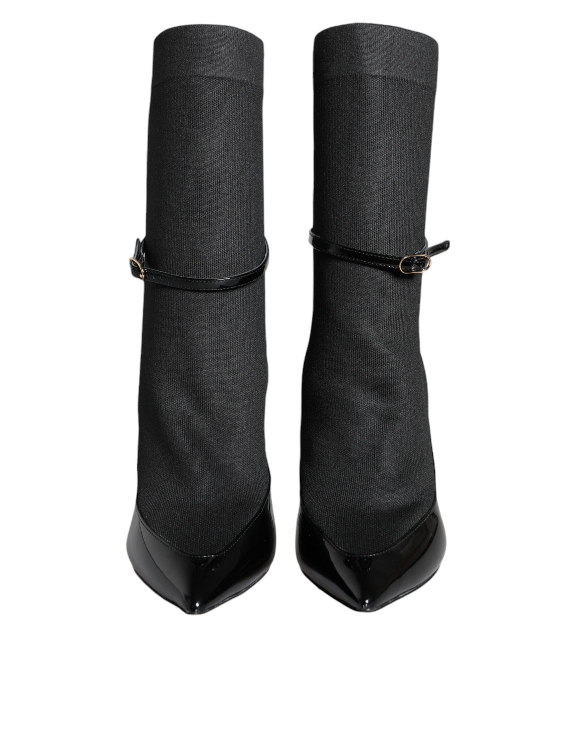 Black leather Dolce & Gabbana stiletto booties with high heels and sock-style design, showcasing sleek and elegant footwear.