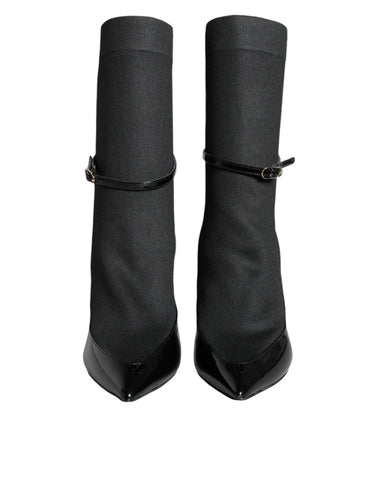 Black leather Dolce & Gabbana stiletto booties with high heels and sock-style design, showcasing sleek and elegant footwear.
