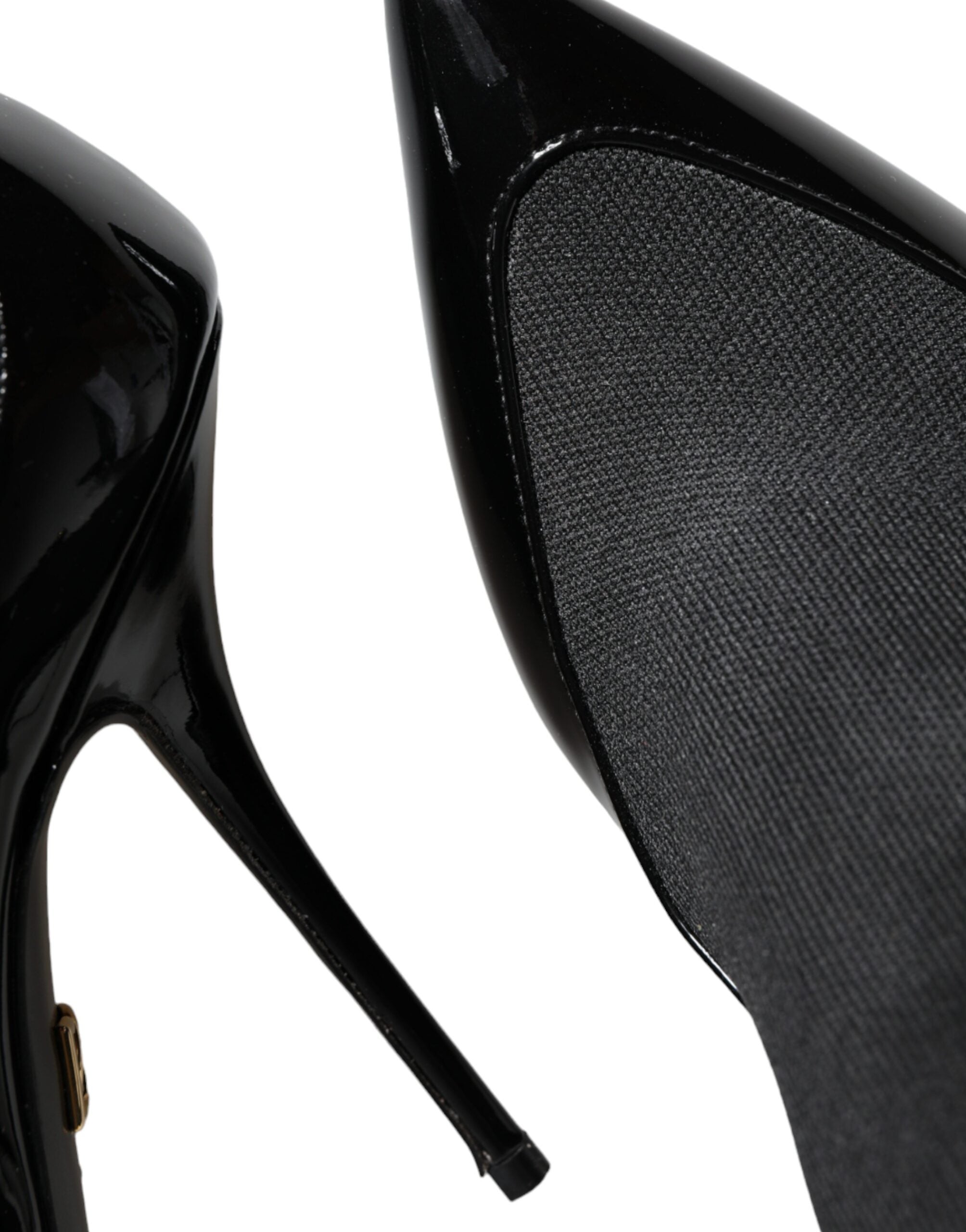 Black leather Dolce & Gabbana stiletto booties with ankle socks, featuring pointed toes and sleek high heels.