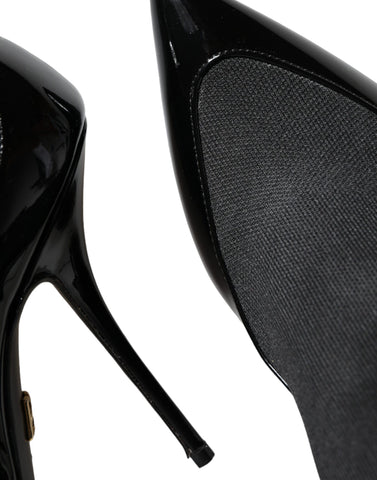 Black leather Dolce & Gabbana stiletto booties with ankle socks, featuring pointed toes and sleek high heels.