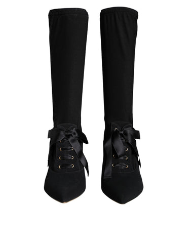 Black Dolce & Gabbana stiletto heels and mid-calf boots displayed, showcasing sleek design and high-heeled footwear style.