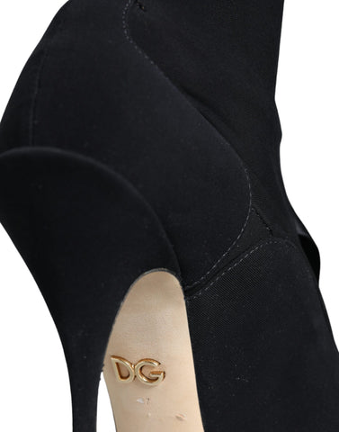 Black Dolce & Gabbana stiletto heels and mid-calf boots with sleek design and pointed toes, stylish footwear for elegant outfits.
