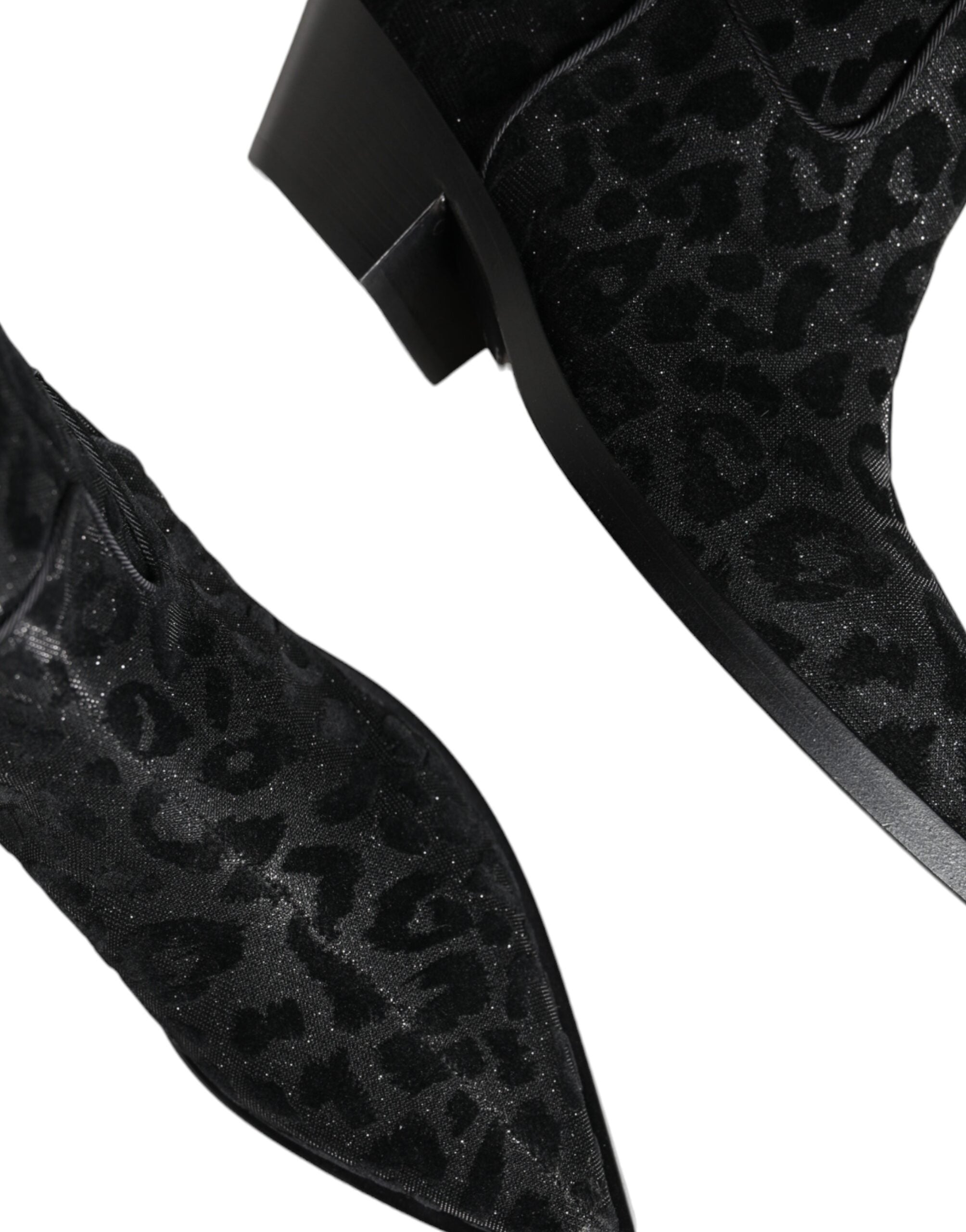 Black and gray leopard print cowboy boots by Dolce & Gabbana, featuring pointed toes and classic Western-style design.