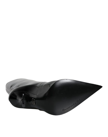 Black patent leather mid-calf boots by Dolce & Gabbana, featuring sleek design and stylish ankle-high silhouette.