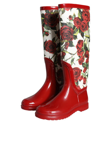 Red floral rubber knee-high flat boots by Dolce & Gabbana, featuring vibrant floral pattern and sleek flat sole design.