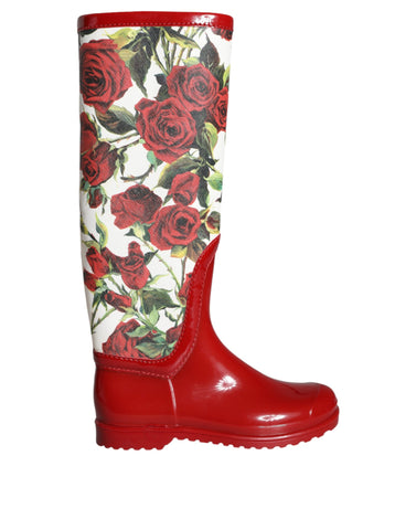 Red floral rubber knee-high flat boots from Dolce & Gabbana with vibrant floral patterns and waterproof design.