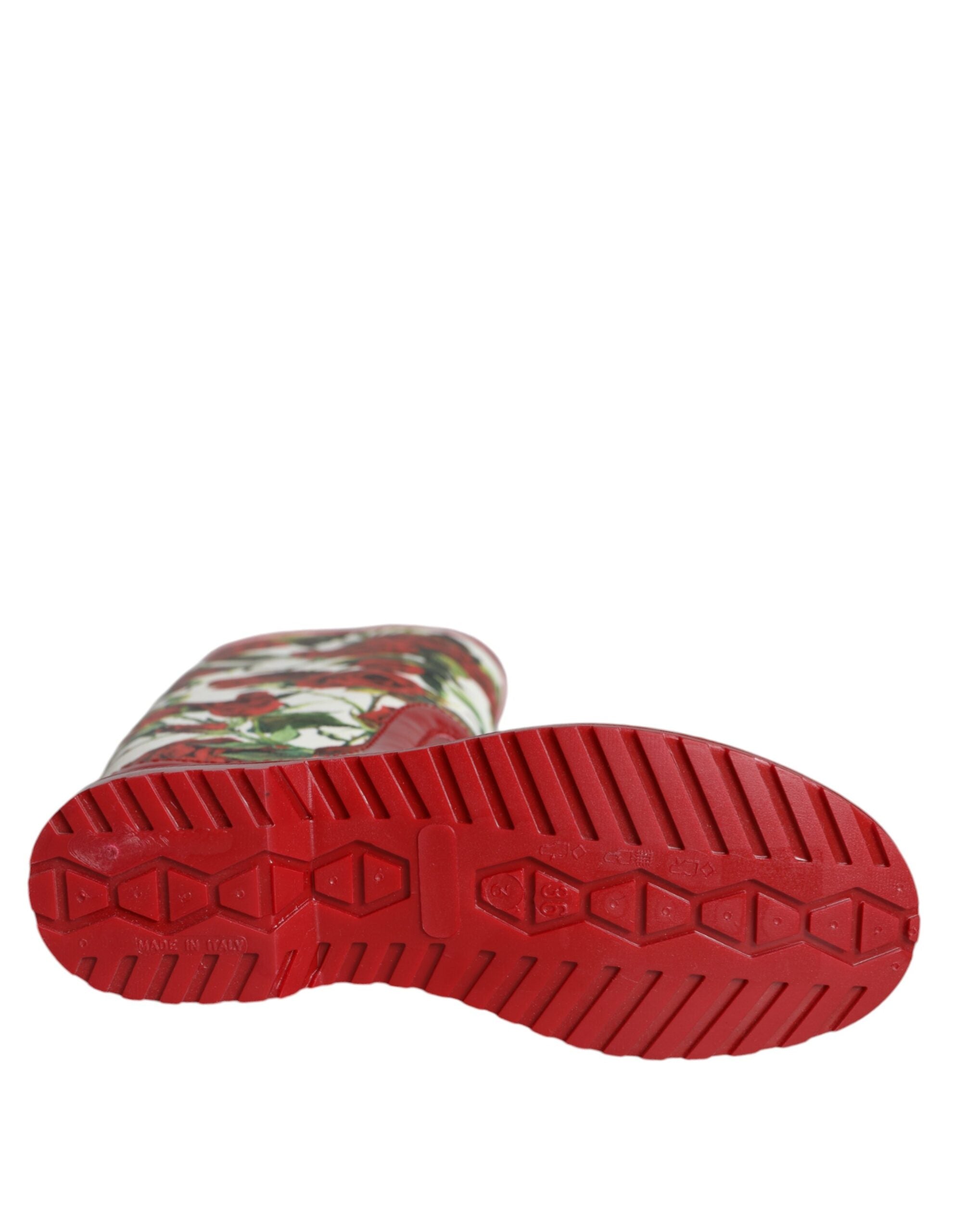 Red floral rubber knee-high flat boots by Dolce & Gabbana featuring a vibrant floral pattern and smooth rubber finish.