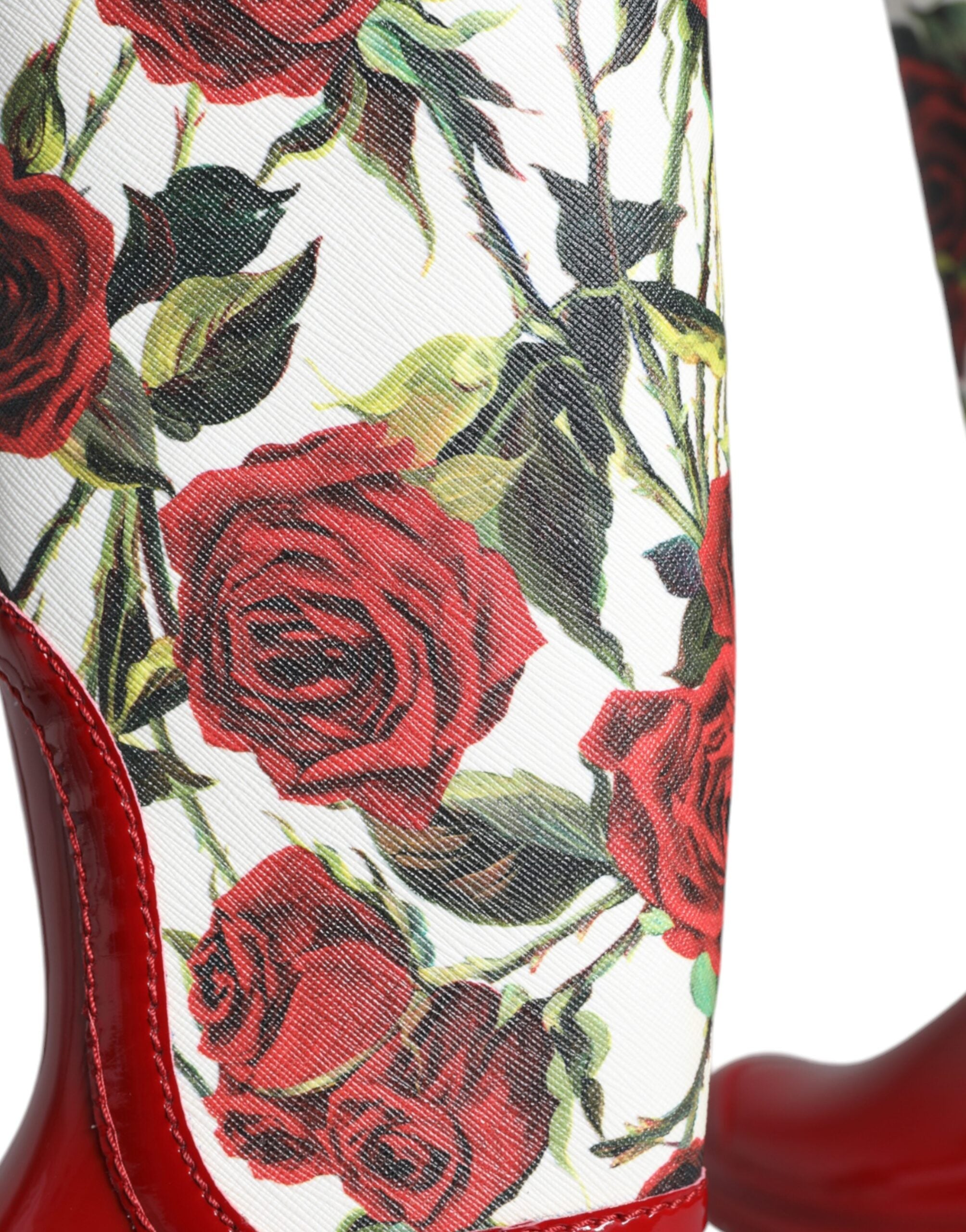 Red floral rubber knee-high flat boots from Dolce & Gabbana with vibrant floral pattern and sleek flat design.