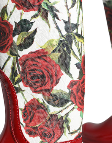 Red floral rubber knee-high flat boots from Dolce & Gabbana with vibrant floral pattern and sleek flat design.